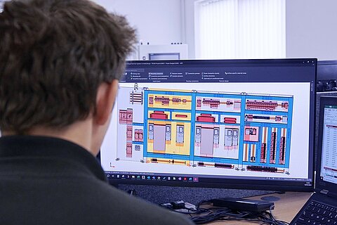 An employee planning automation solutions on the computer.